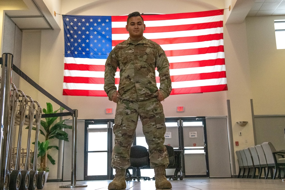 U.S. Space Force logistics readiness airman standing before an American flag